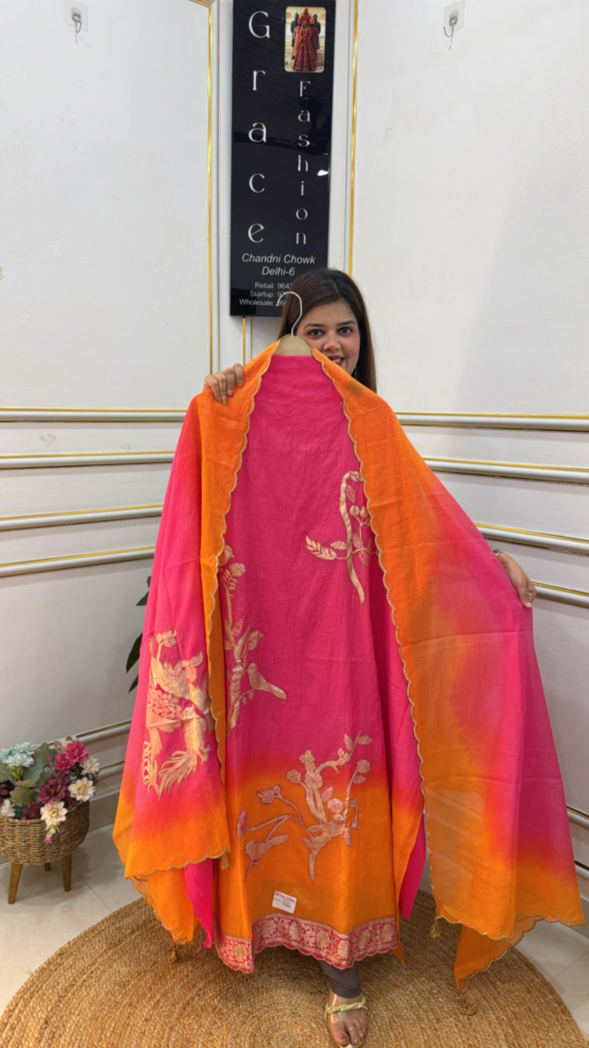 Ombre cotton silk suit in vibrant pink and orange with intricate embroidery showcased by a model